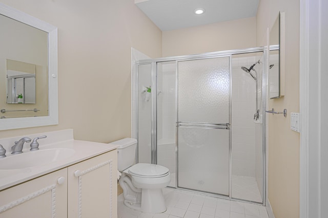 bathroom with walk in shower, vanity, toilet, and tile patterned flooring