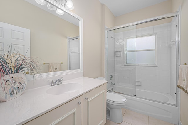 full bathroom with tile patterned flooring, vanity, enclosed tub / shower combo, and toilet