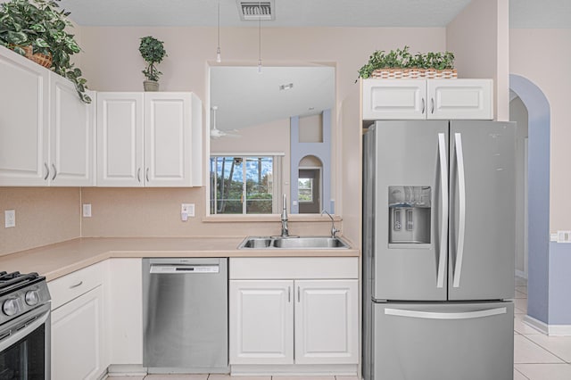 kitchen featuring appliances with stainless steel finishes, sink, and white cabinets