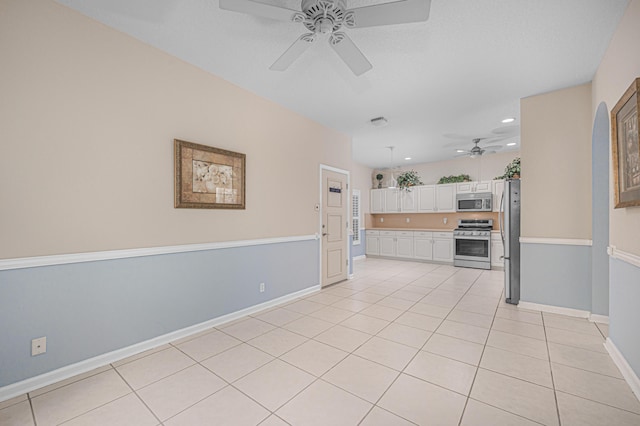 unfurnished living room featuring ceiling fan and light tile patterned floors