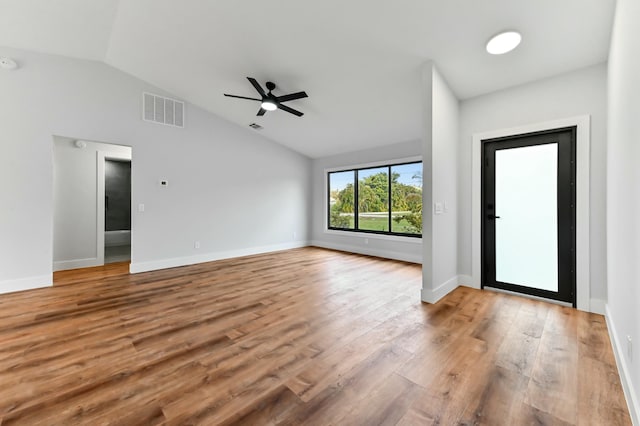 foyer entrance with ceiling fan, vaulted ceiling, and light wood-type flooring