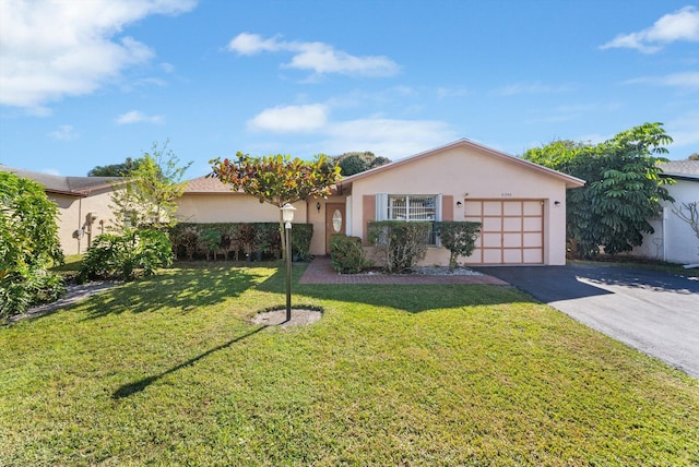 ranch-style home with a garage and a front lawn