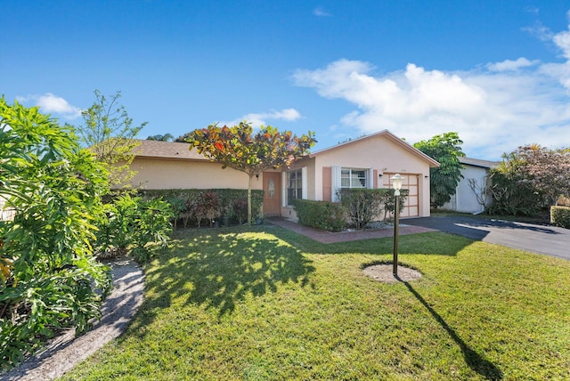 ranch-style house with a garage and a front lawn