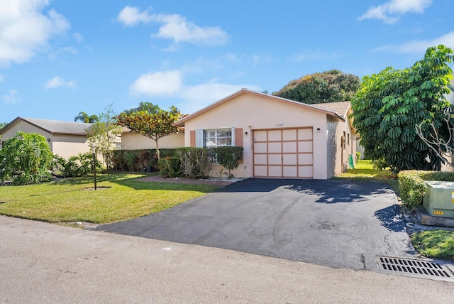 ranch-style house featuring a garage and a front lawn