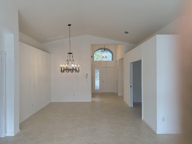 interior space featuring high vaulted ceiling and a chandelier