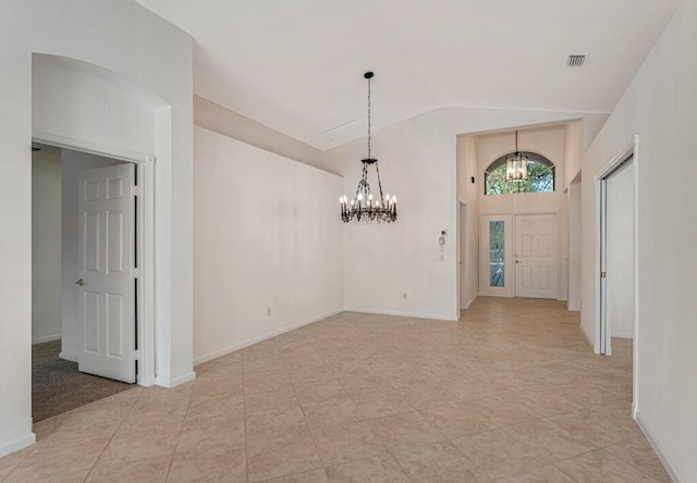 foyer with vaulted ceiling, visible vents, a notable chandelier, and baseboards