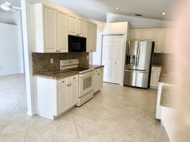 kitchen featuring lofted ceiling, stainless steel fridge, white range with electric cooktop, decorative backsplash, and white cabinets