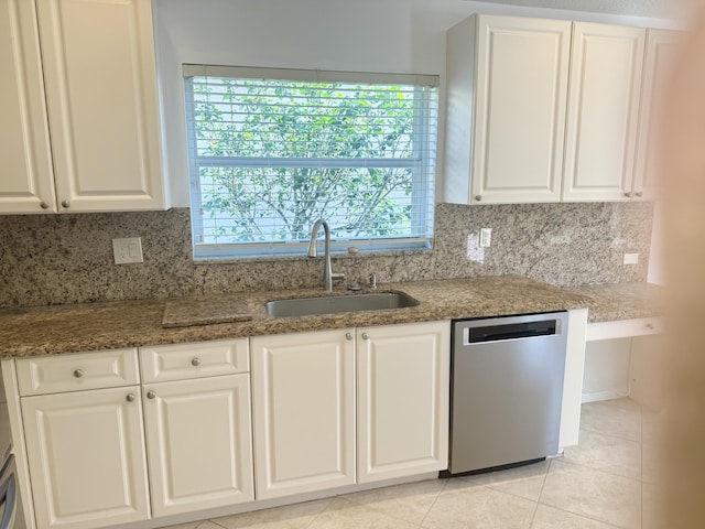 kitchen featuring tasteful backsplash, dishwasher, sink, and white cabinets