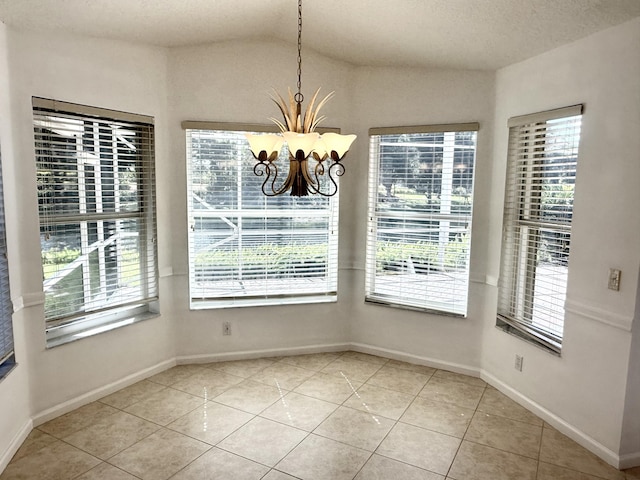 unfurnished dining area with light tile patterned flooring, vaulted ceiling, and a notable chandelier