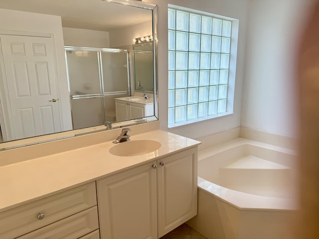 bathroom with independent shower and bath and vanity