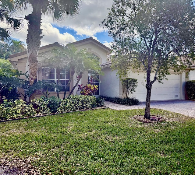 view of front of house featuring a garage and a front lawn