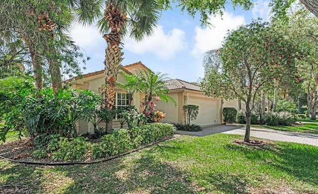 view of front of property featuring driveway, an attached garage, a tiled roof, and stucco siding