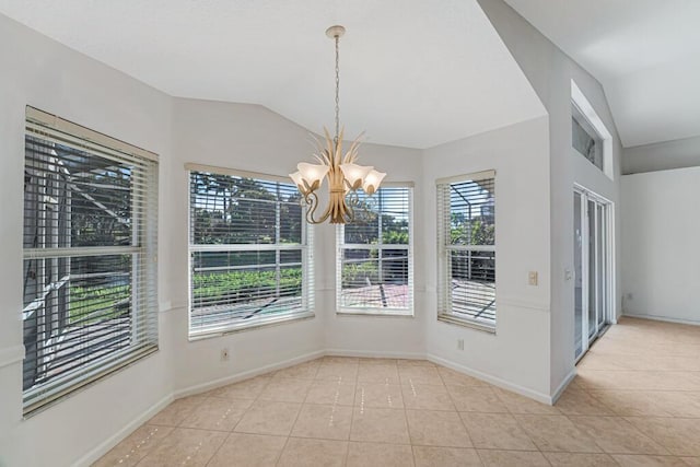 unfurnished dining area featuring a chandelier, vaulted ceiling, baseboards, and tile patterned floors