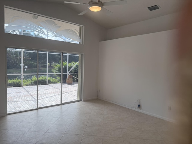 tiled spare room with lofted ceiling and ceiling fan