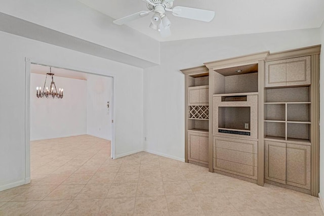 unfurnished living room with light tile patterned flooring, vaulted ceiling, baseboards, and ceiling fan with notable chandelier