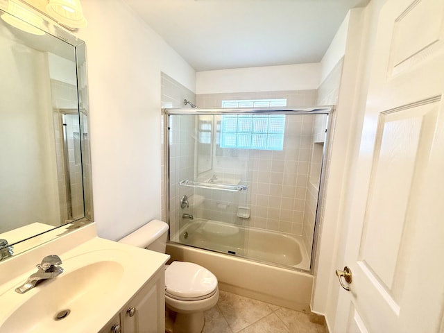 full bathroom featuring vanity, tile patterned floors, enclosed tub / shower combo, and toilet