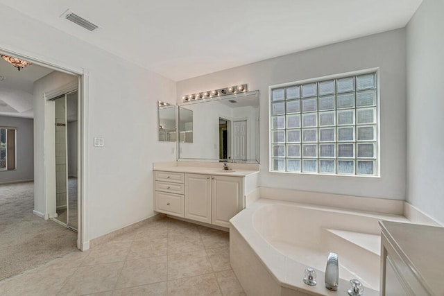 full bathroom with tile patterned flooring, vanity, visible vents, baseboards, and a bath