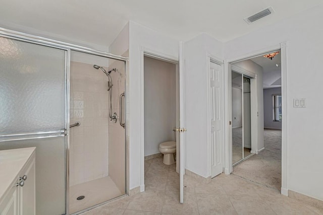 full bathroom featuring toilet, a stall shower, tile patterned flooring, and visible vents