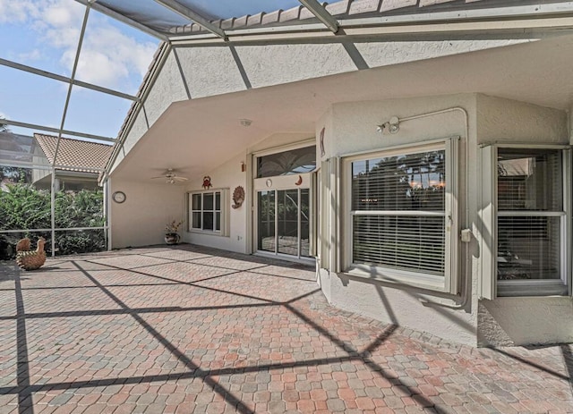 view of patio featuring ceiling fan and a lanai