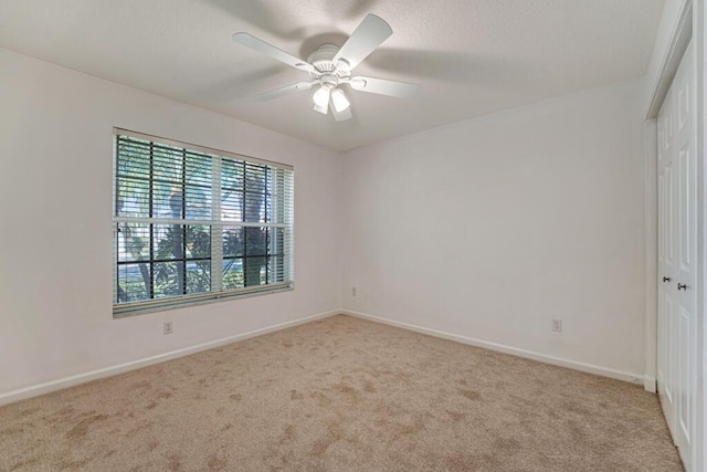 unfurnished room featuring ceiling fan, baseboards, and carpet flooring