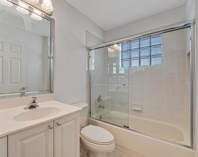 full bathroom with vanity, toilet, and bath / shower combo with glass door