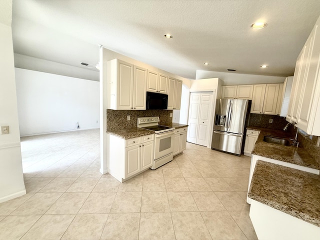 kitchen with stainless steel fridge with ice dispenser, sink, decorative backsplash, and white range with electric stovetop