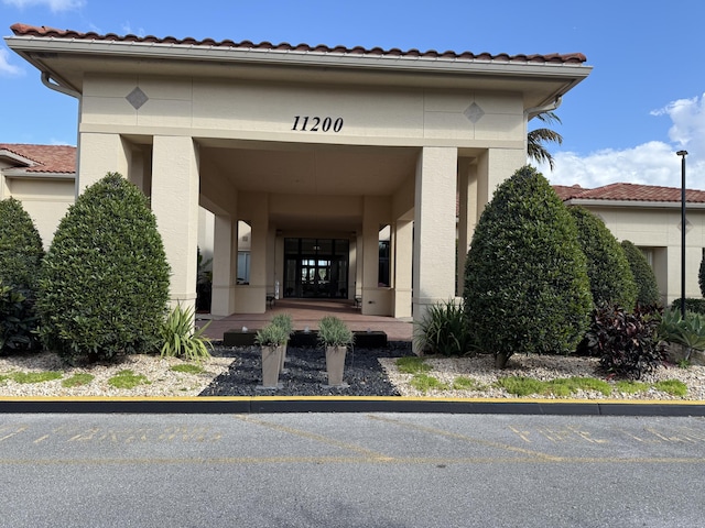 entrance to property with stucco siding