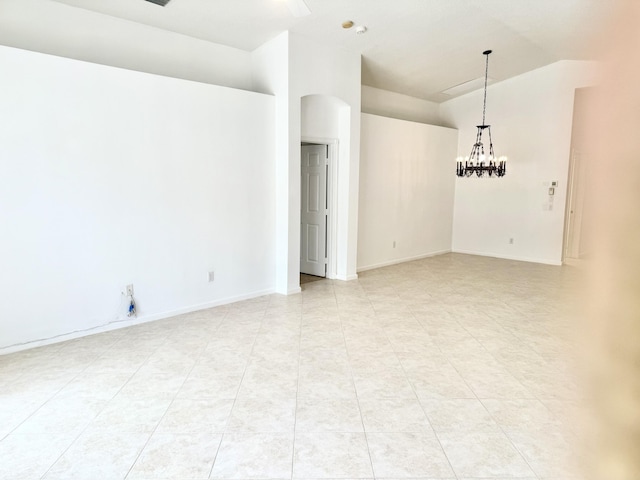 unfurnished room with vaulted ceiling and an inviting chandelier