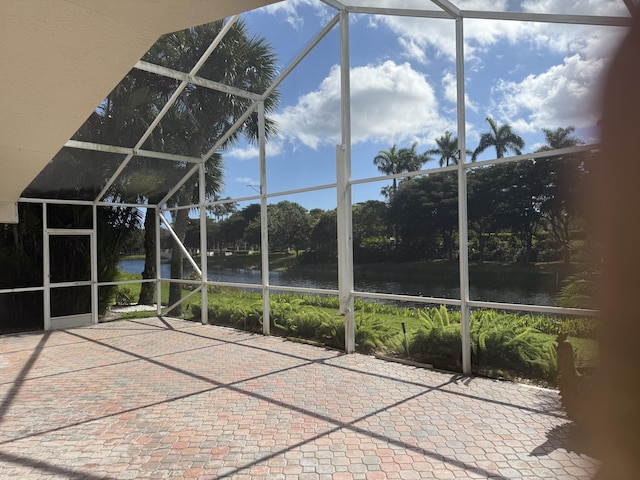 unfurnished sunroom with a water view