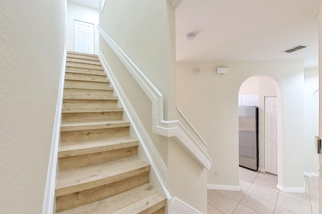 stairway with tile patterned flooring