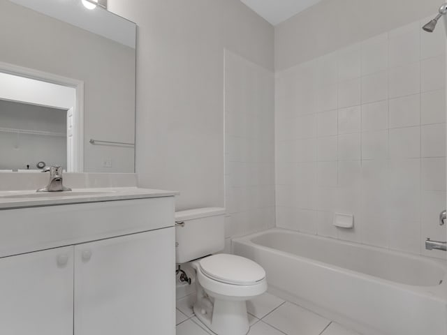 full bathroom featuring tiled shower / bath, tile patterned floors, toilet, and vanity