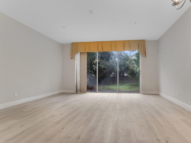 unfurnished room with light wood-type flooring