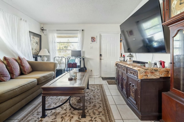 tiled living room featuring a textured ceiling