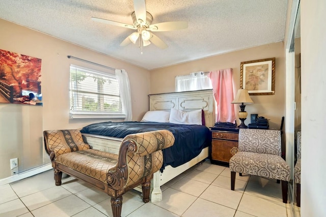 tiled bedroom with ceiling fan and a textured ceiling