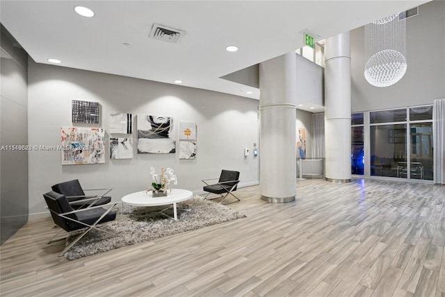 interior space with ornate columns and light wood-type flooring