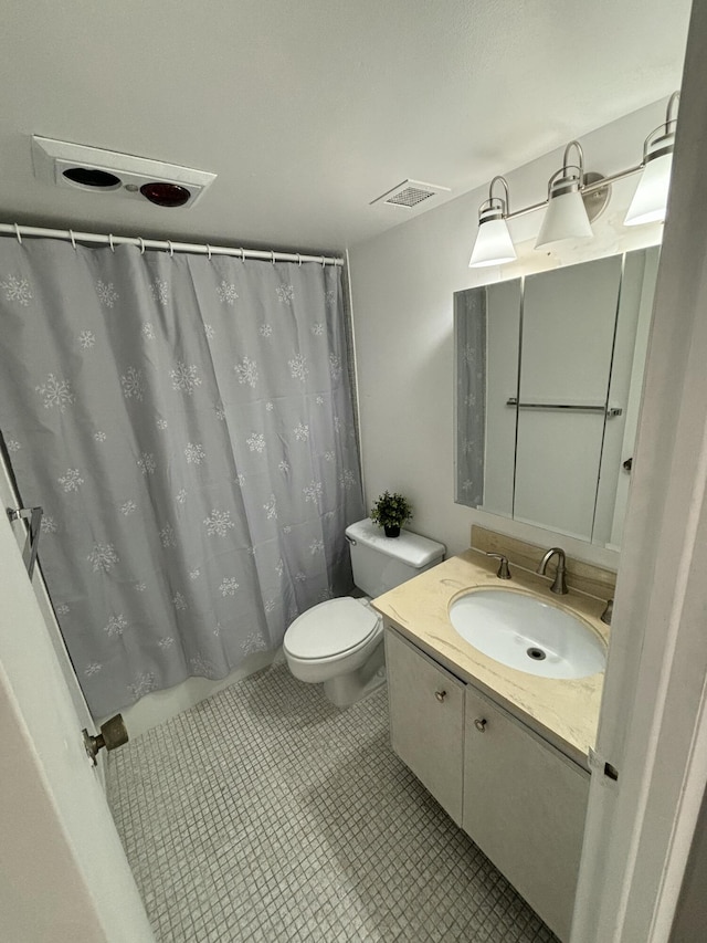 bathroom with vanity, toilet, curtained shower, and tile patterned flooring