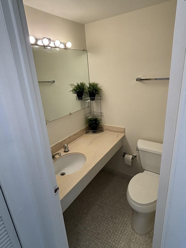 bathroom featuring tile patterned flooring, sink, and toilet