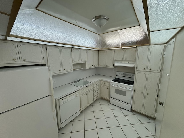 kitchen featuring sink, white appliances, and light tile patterned floors