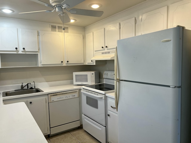 kitchen with sink, white appliances, light tile patterned floors, ceiling fan, and white cabinets