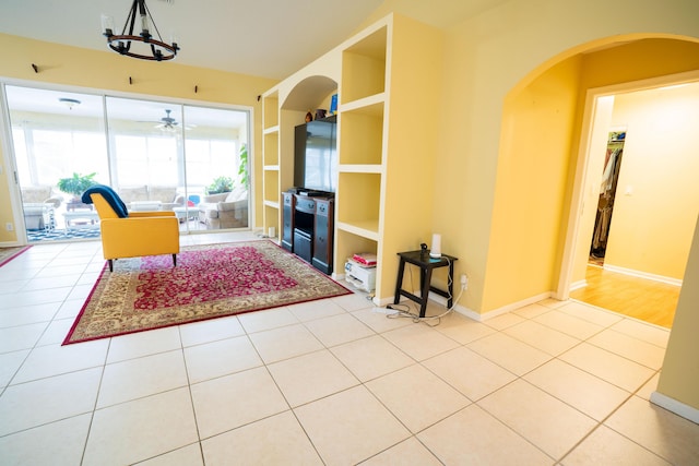 165 Cypress Trce, Royal Palm Beach, FL 33411 - living area featuring ceiling fan, tile patterned floors, arched walkways, a chandelier, and baseboards