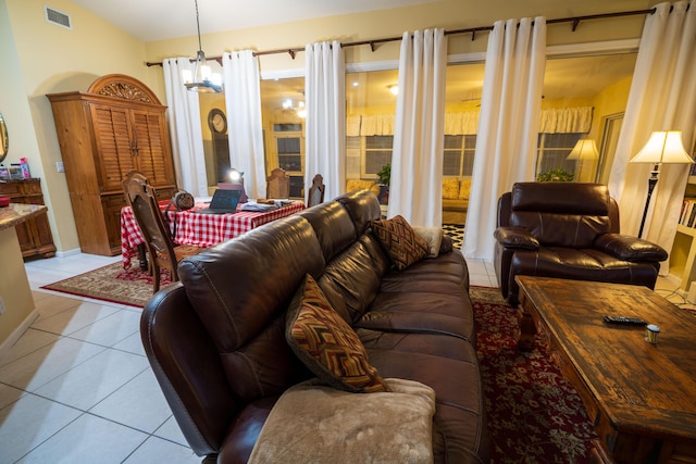 living room featuring a chandelier and light tile patterned flooring