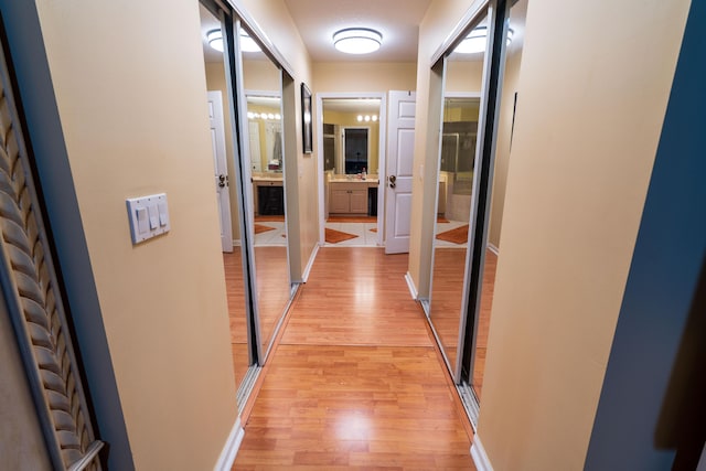 corridor with light hardwood / wood-style floors