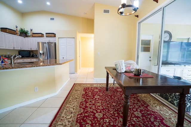 165 Cypress Trce, Royal Palm Beach, FL 33411 - kitchen with stainless steel fridge with ice dispenser, light tile patterned floors, a chandelier, dark stone countertops, and white cabinets