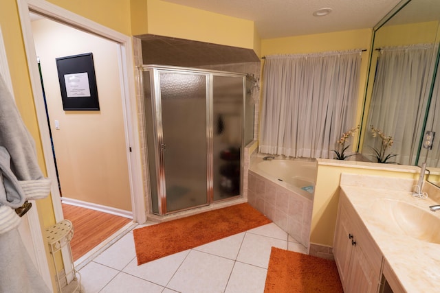 bathroom featuring vanity, separate shower and tub, and tile patterned floors