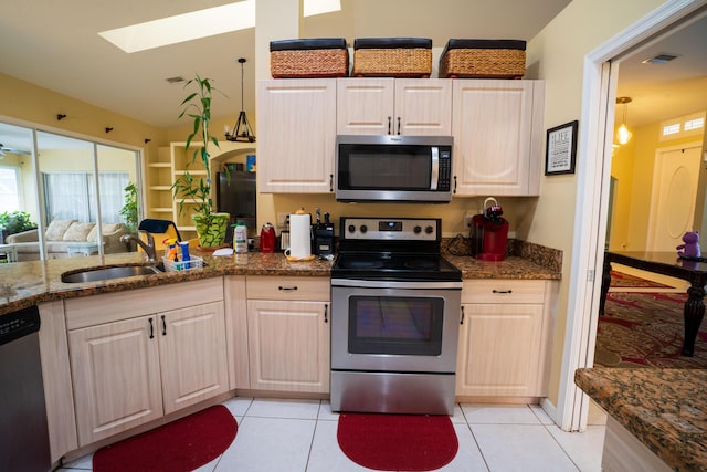 165 Cypress Trce, Royal Palm Beach, FL 33411 - kitchen featuring stainless steel appliances, a sink, a skylight, and light tile patterned floors