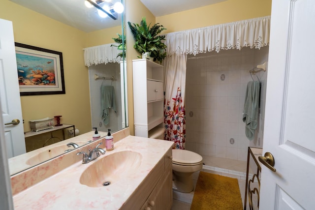 bathroom with a shower with curtain, vanity, tile patterned flooring, and toilet