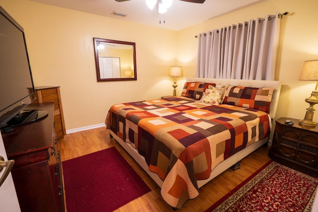 bedroom with light hardwood / wood-style flooring and ceiling fan