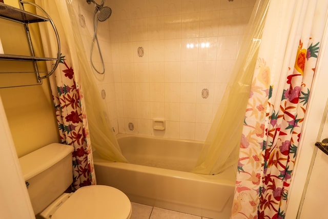 bathroom featuring tile patterned flooring, shower / bath combination with curtain, and toilet