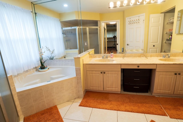 165 Cypress Trce, Royal Palm Beach, FL 33411 - bathroom featuring double vanity, a shower stall, a garden tub, and tile patterned flooring