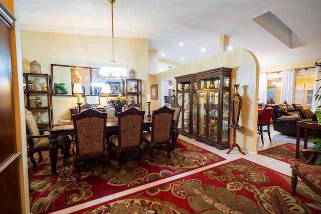 tiled dining room with an inviting chandelier